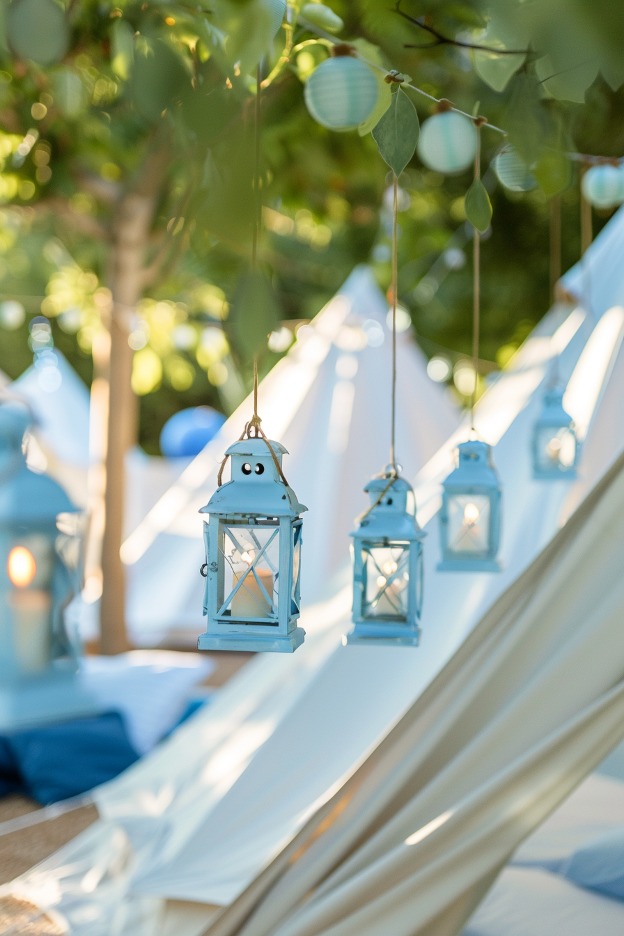 Blue themed glamping. baby blue tinted hanging lanterns scattered in the roofs of white canvas bell tents.