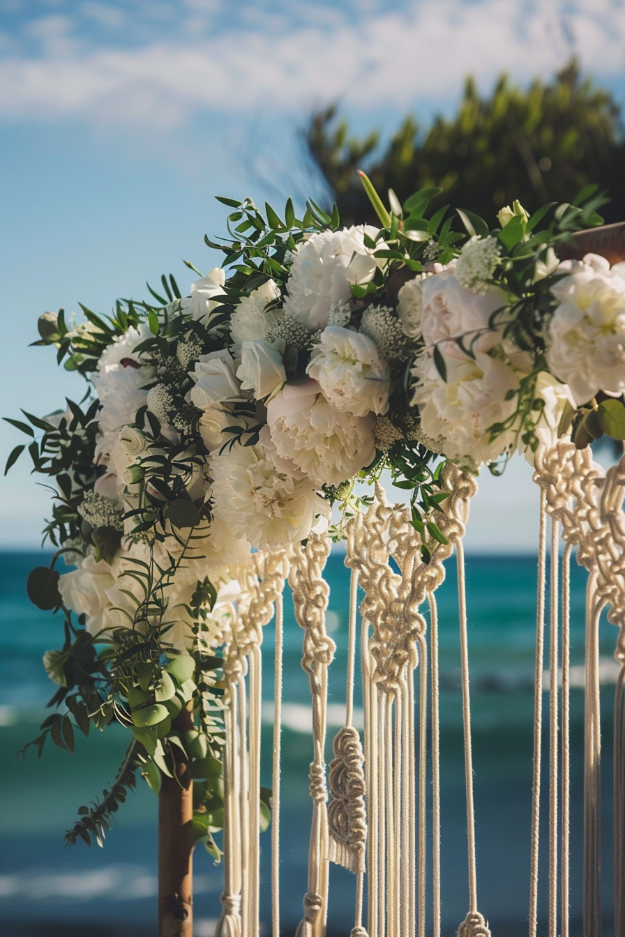 Boho beach wedding. Draped macrame backdrop with white peonies.