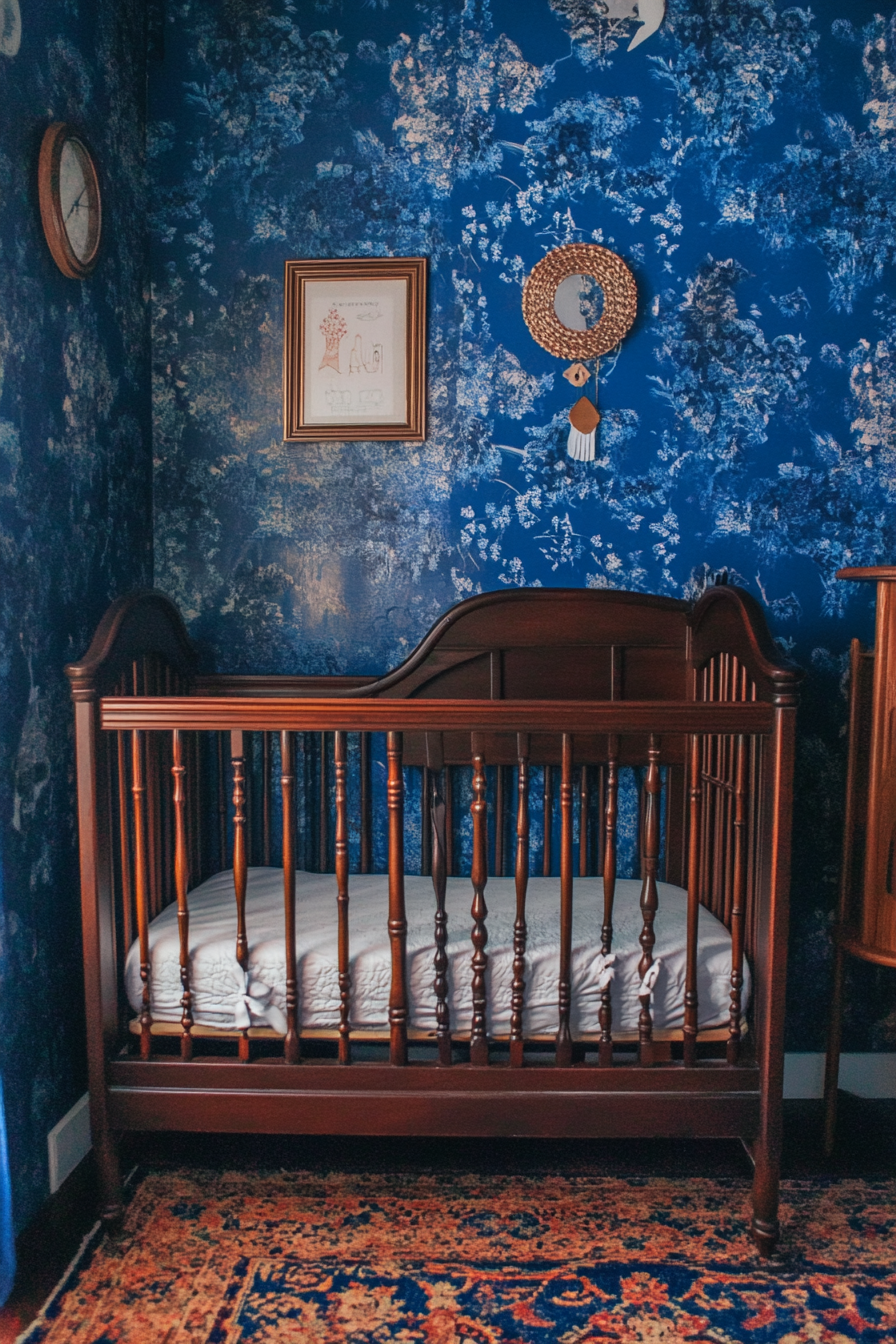 Tiny house nursery. Wall-mounted crib against deep blue wallpaper.