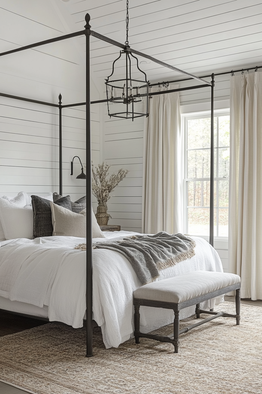 Rustic-chic bedroom. White shiplap ceilings with four-poster iron bed frame.