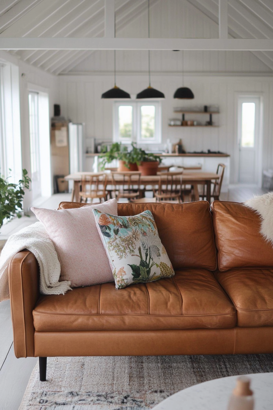 Boho-Farmhouse living space. Leather couch with pastel throw pillows.