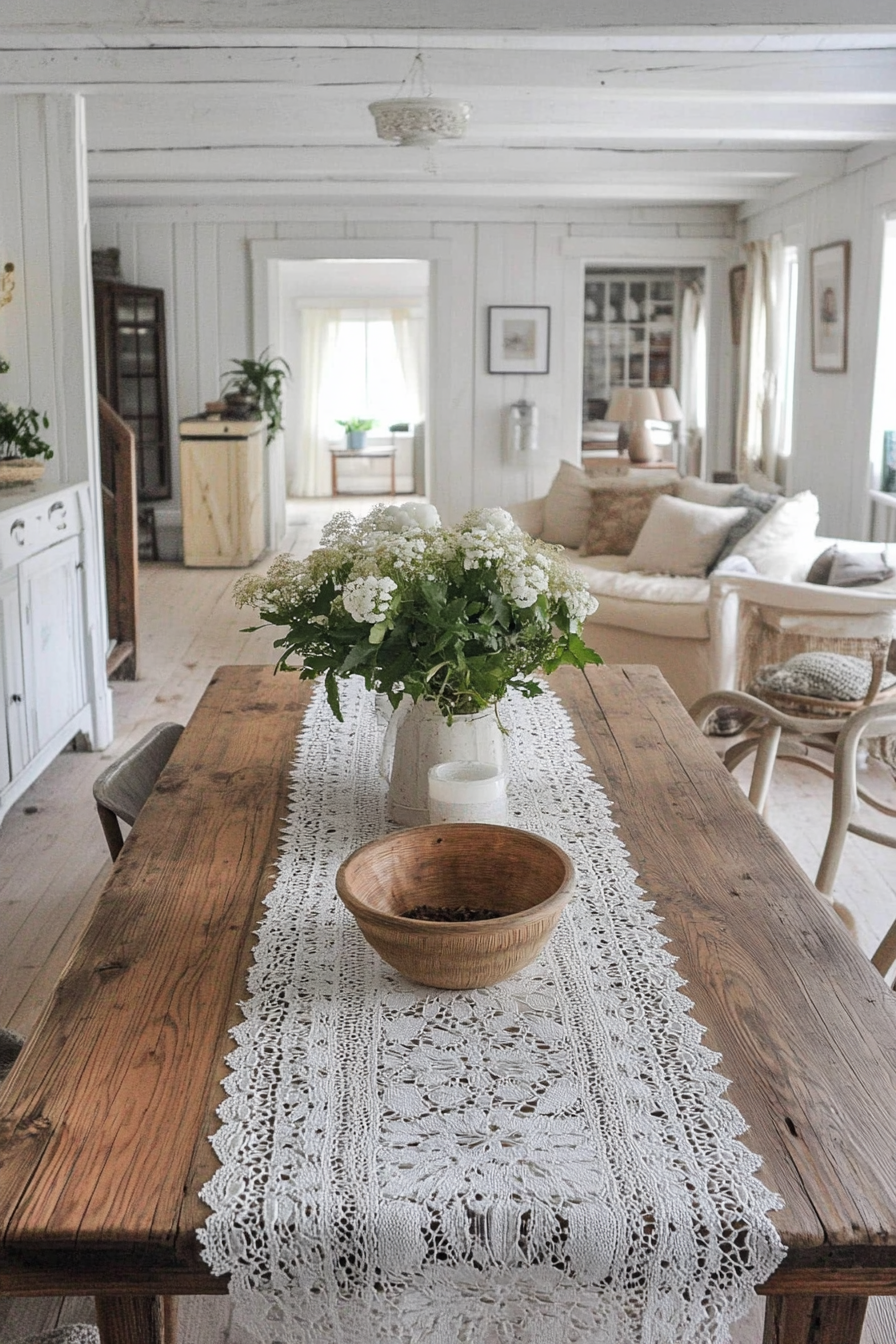 Boho-Farmhouse living space. Rustic wood table with white lacy runner.